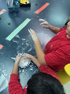 Students making Oobleck (green slime) in science class