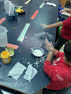 Students making Oobleck (green slime) in science class