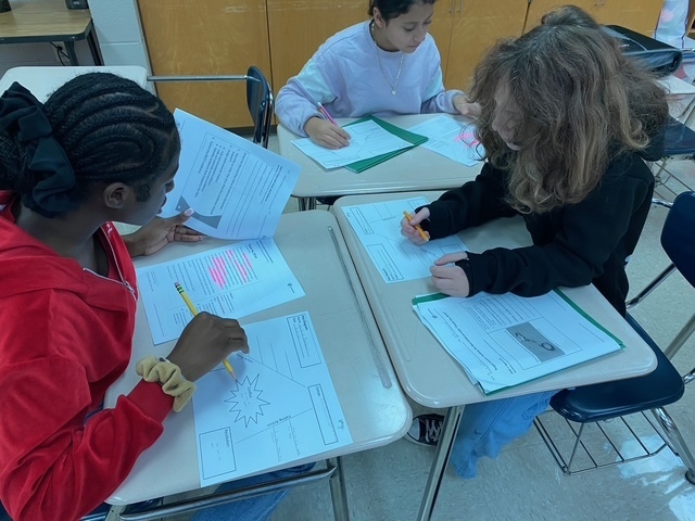 Students working in small groups on plot diagrams.