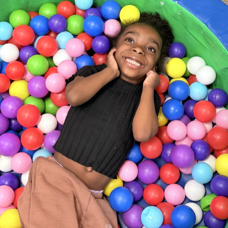  student playing in ball pit