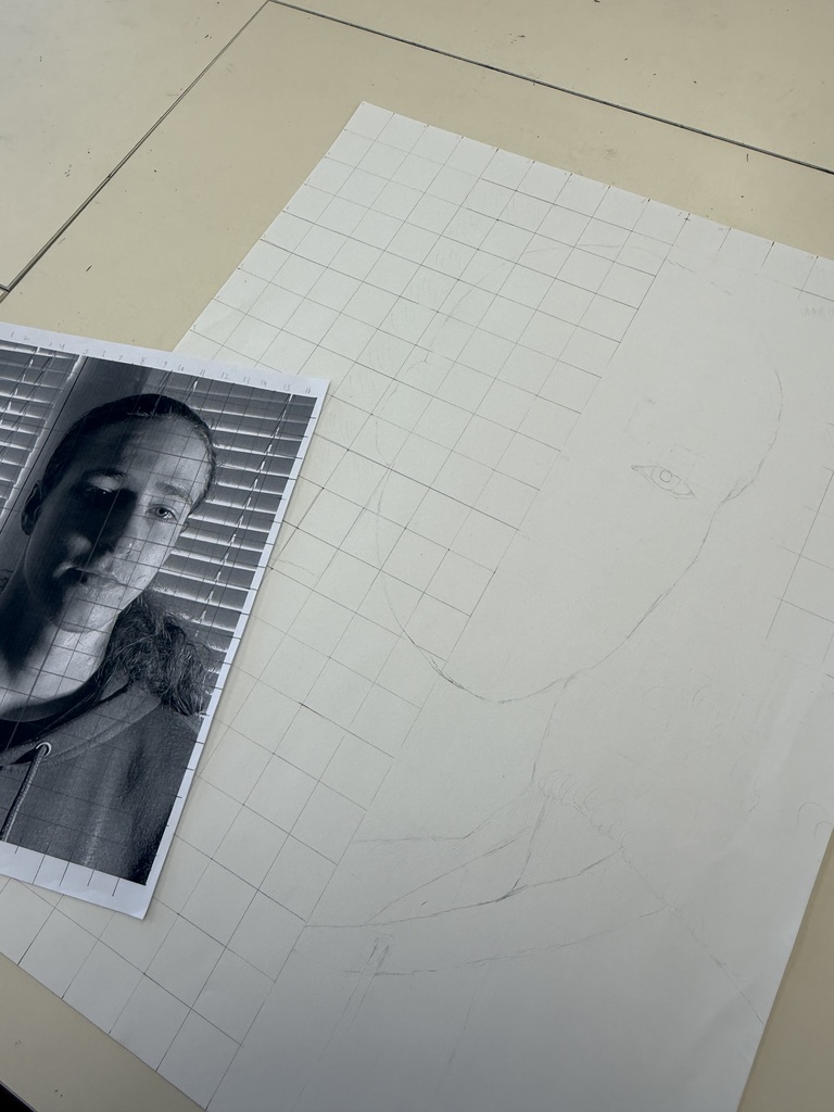 Students begin drawing altered self portraits.