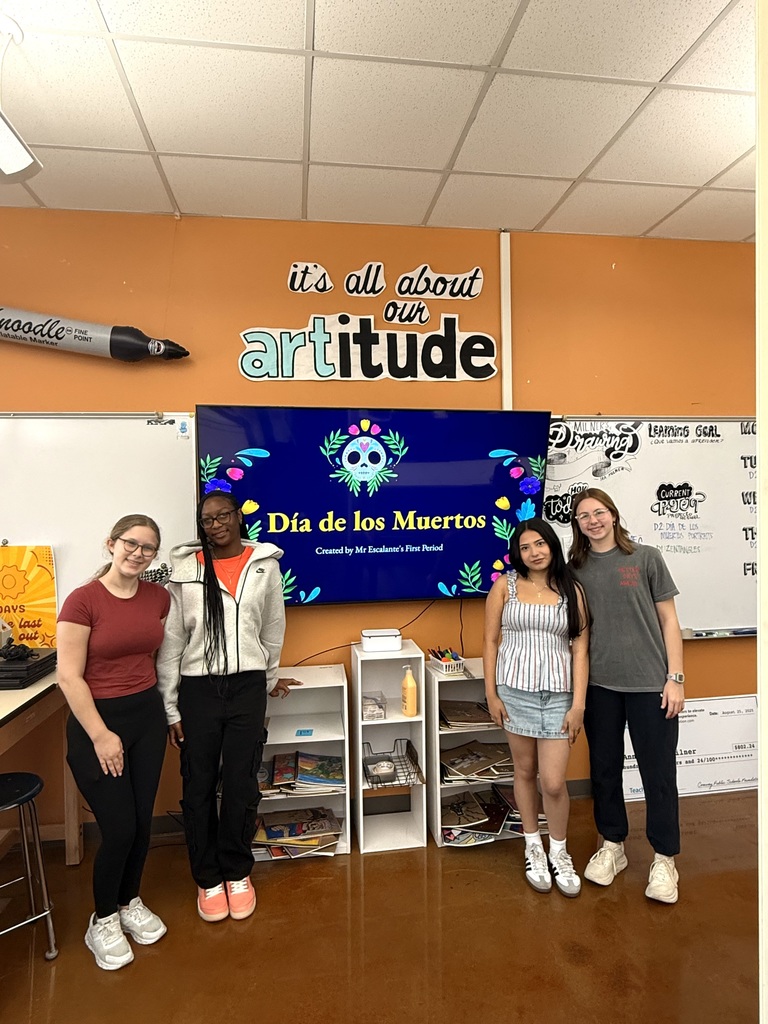 Mr. Escalante's students posing in front of their presentation screen.
