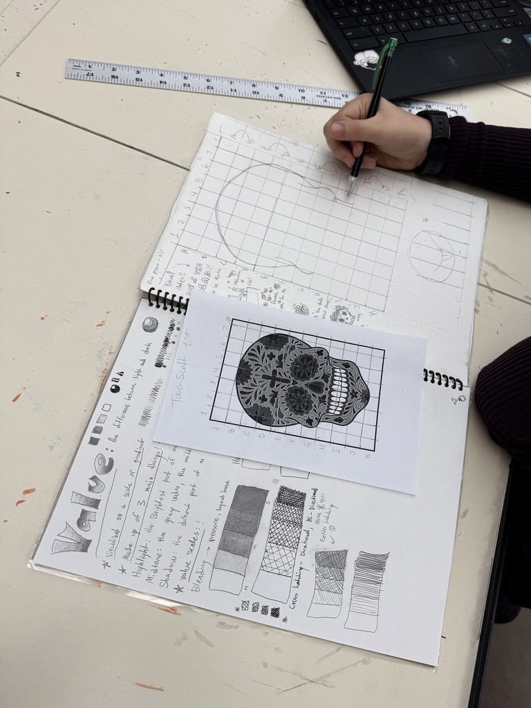 A student's notebook displaying the illustrated notes and calavera.