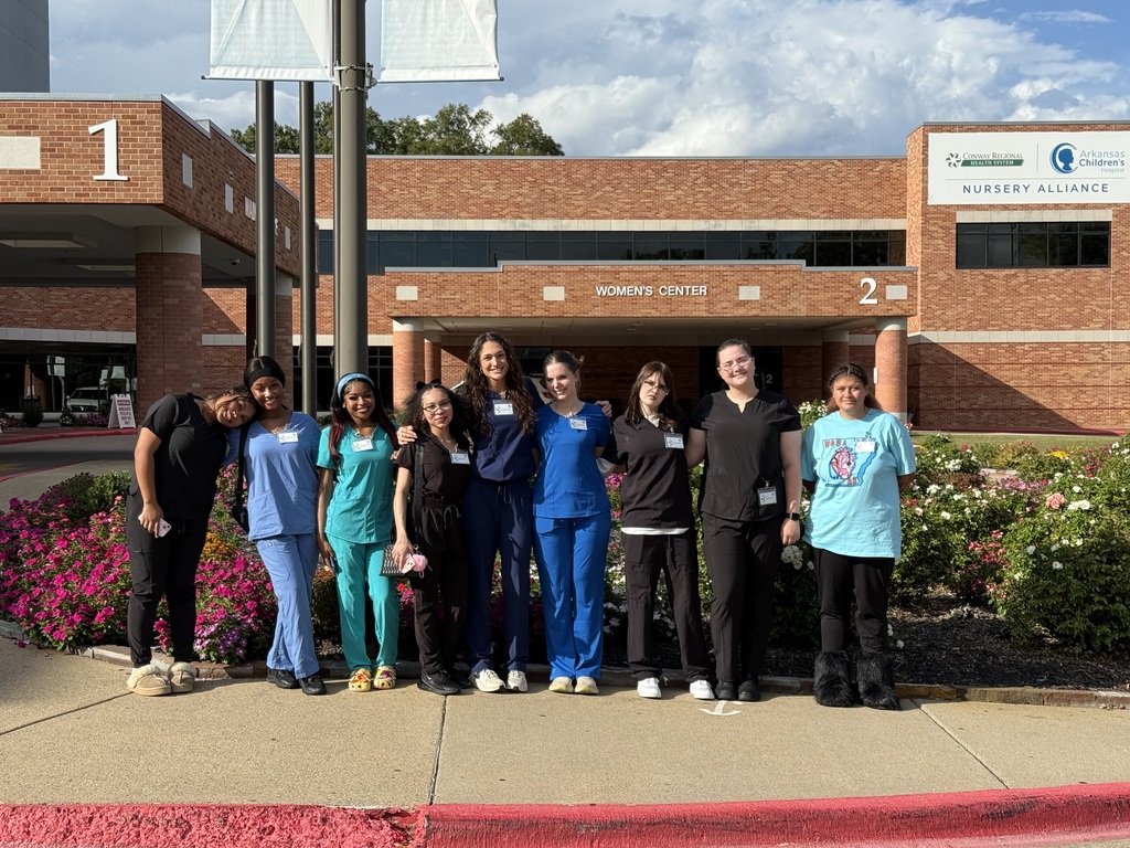 Students standing in front of the Conway Regional Medical Center.
