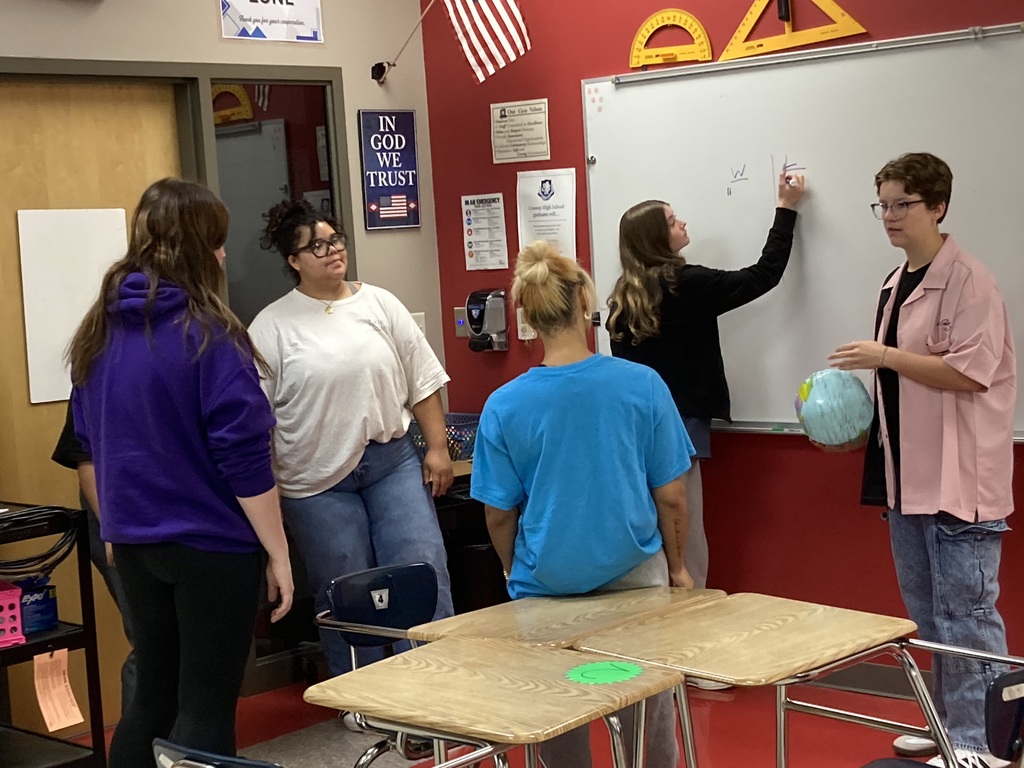 Students discuss their results and record it on the marker board.