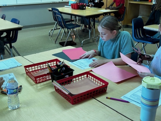 students using manipulatives to divide fractions
