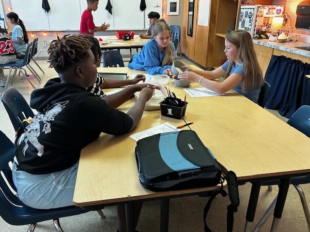 students using manipulatives to divide fractions