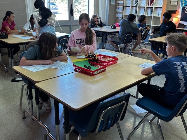 students using manipulatives to divide fractions