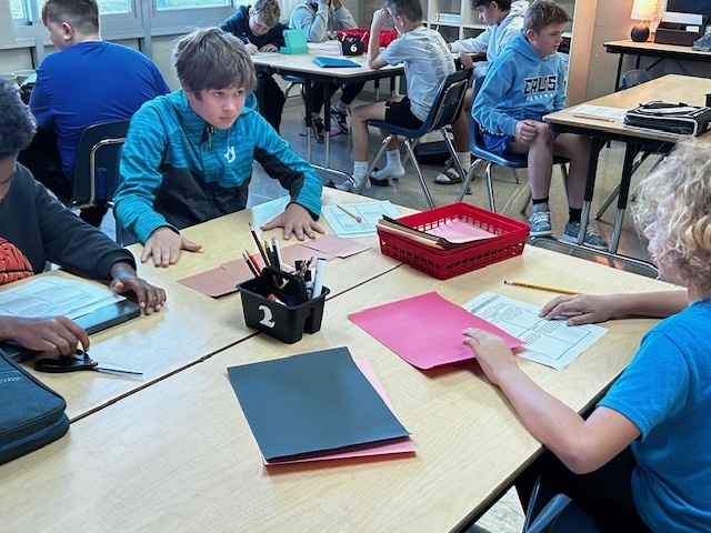 students using manipulatives to divide fractions