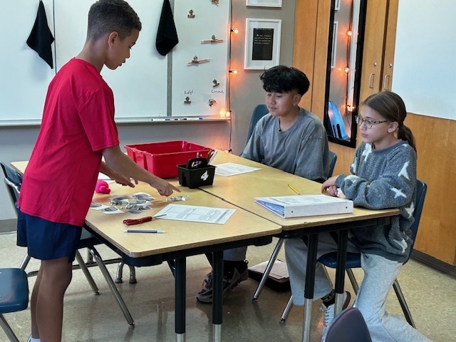 students using manipulatives to divide fractions