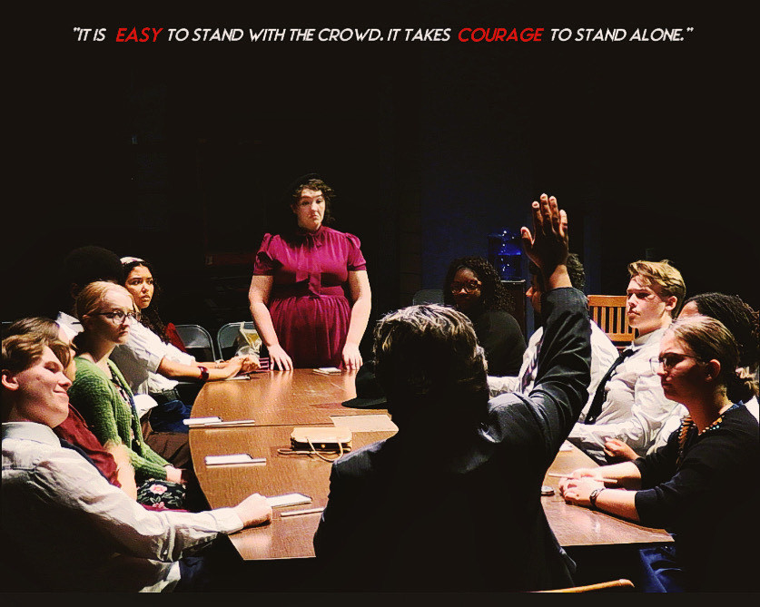 Actors for the play 12 Angry Jurors sit around a table.