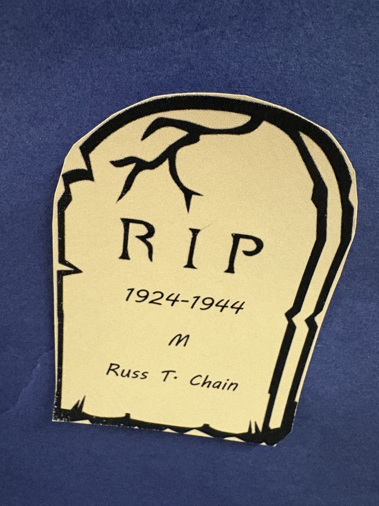 Paper tombstones on a paper graveyard. Students studying the data.