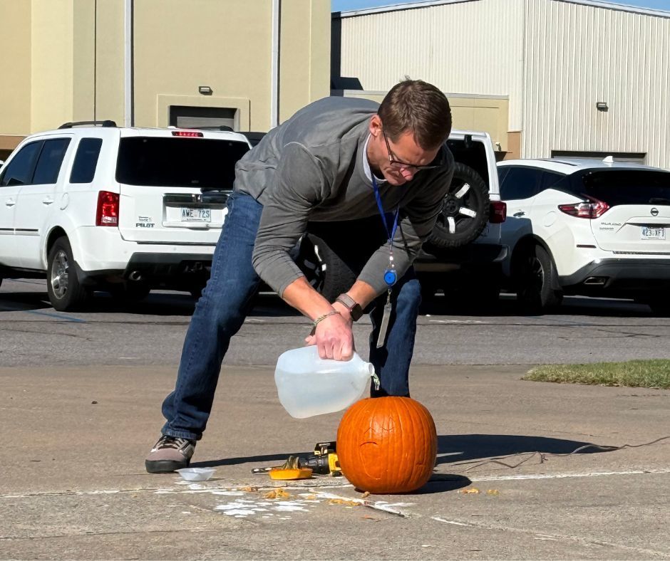 Man adding water to a pumpkin for the experiment.