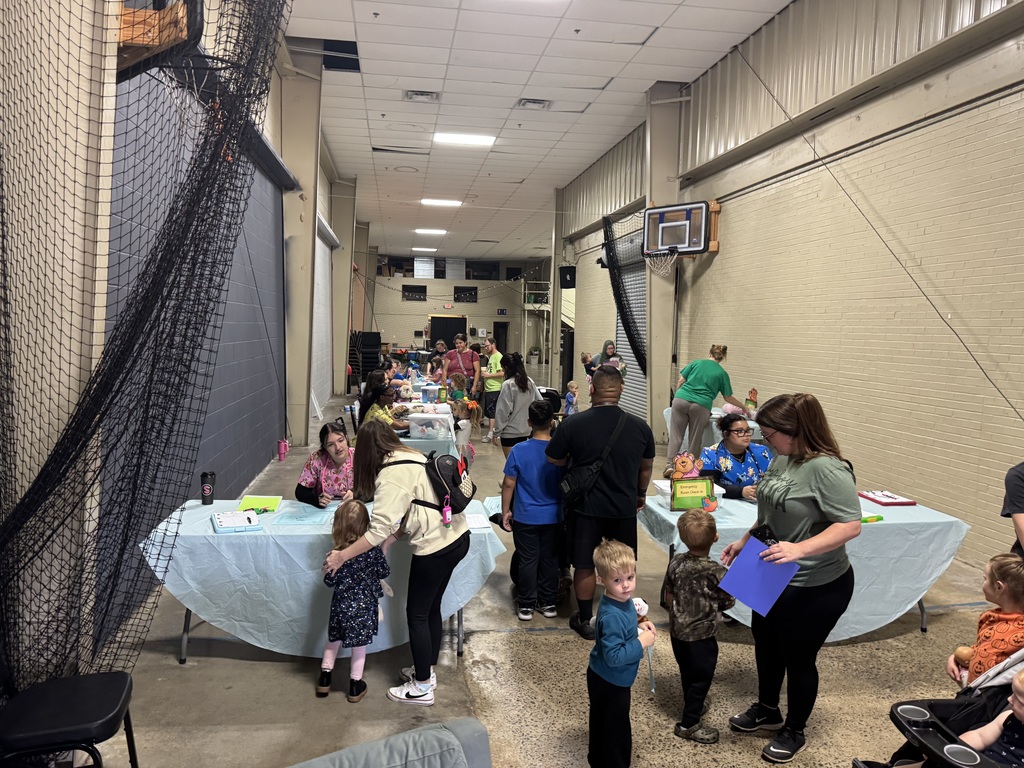 EMR students work with little kids to give their stuffed animals a check up.