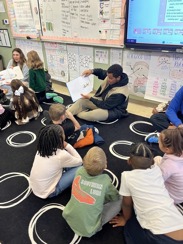High school students reading to elementary students.