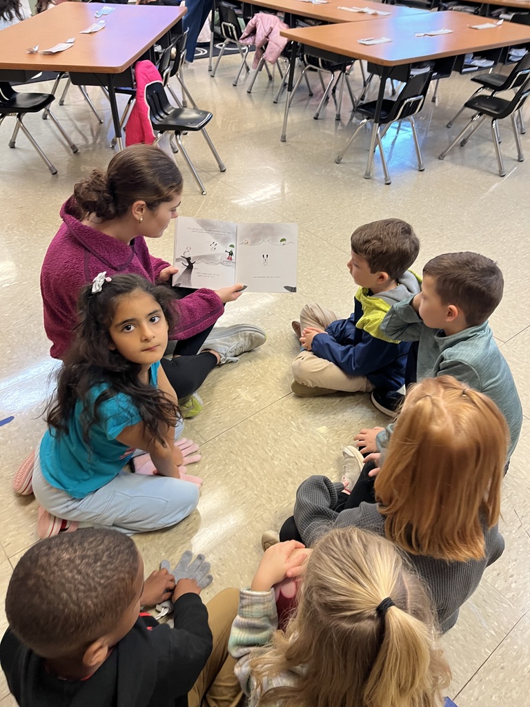 High school students reading to elementary students.