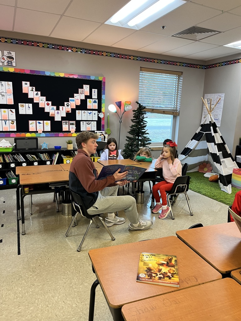 High school students reading to elementary students.