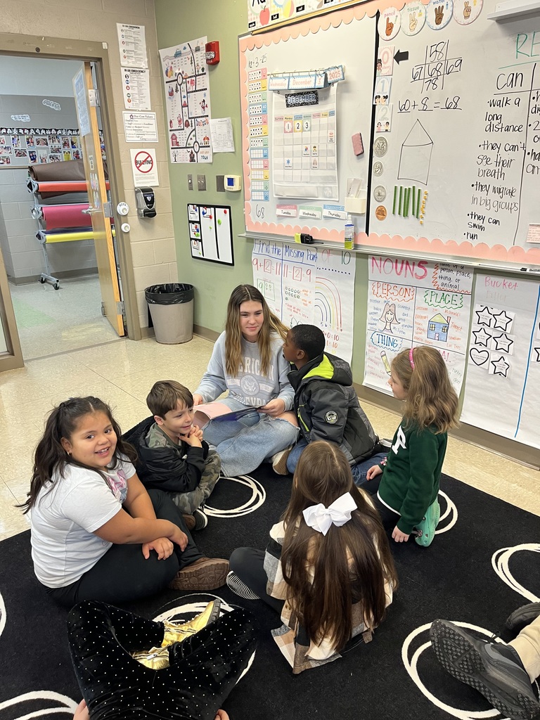 High school students reading to elementary students.