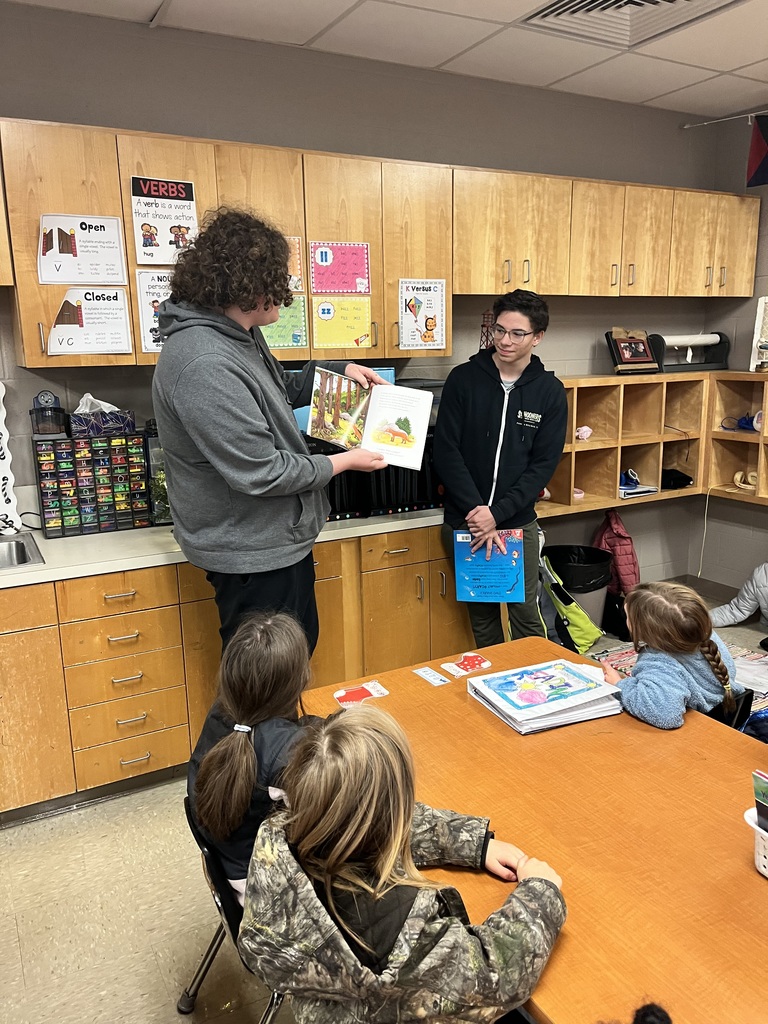 High school students reading to elementary students.