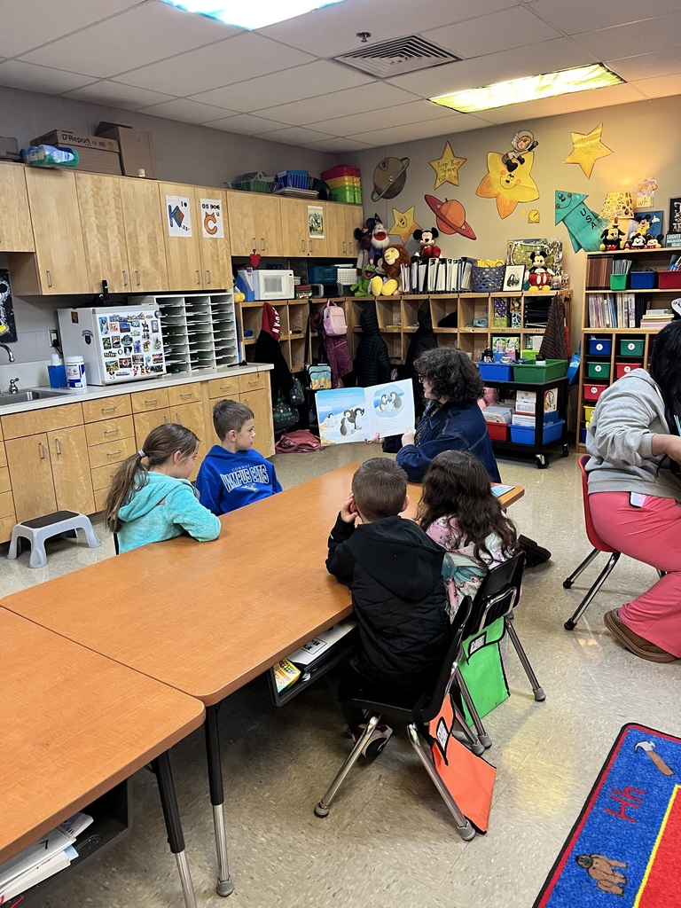 High school students reading to elementary students.