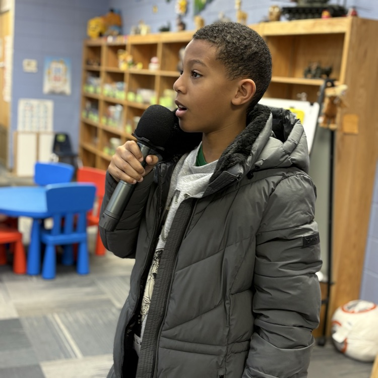 photo of students reading aloud in library 