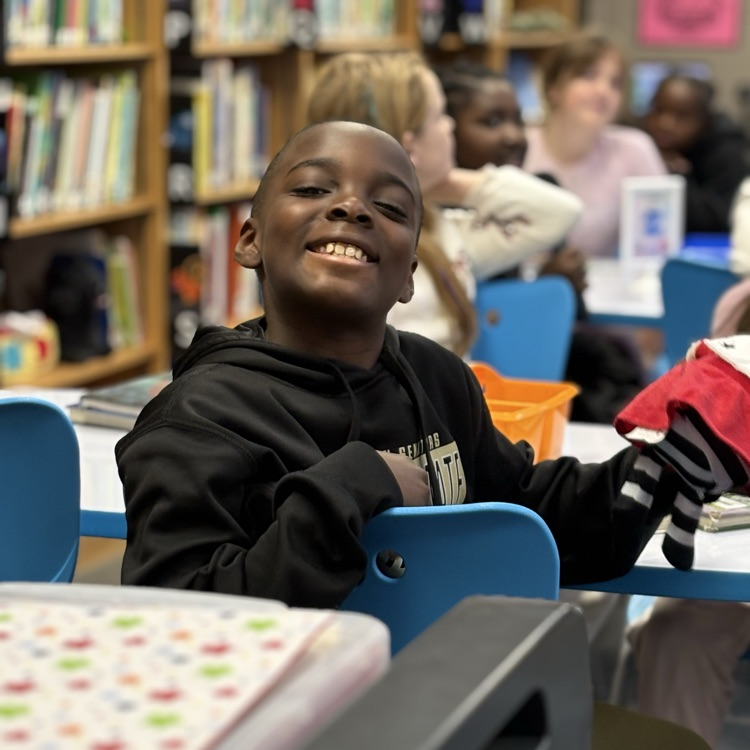 photo of students reading aloud in library 