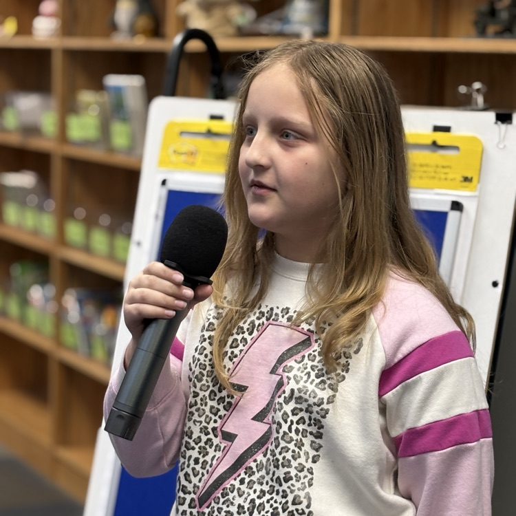 photo of students reading aloud in library 