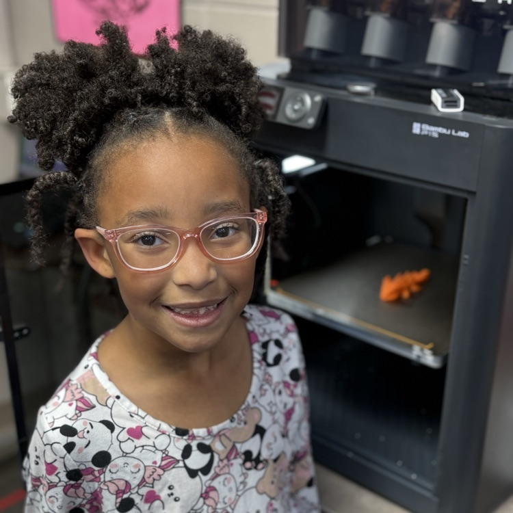 student picture in front of 3D printer 