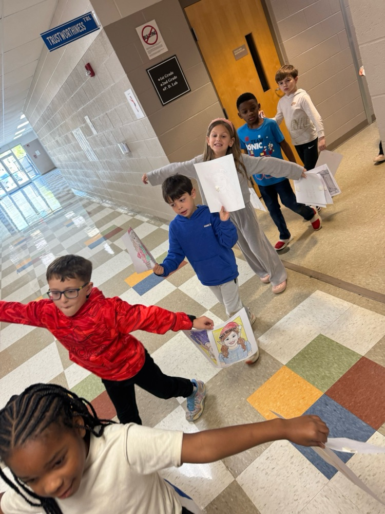 Mrs. Jones and Mrs. Briggler were pranked by the second-grade classes today. They colored elf coloring sheets with their faces and decorated the halls and their offices with them. 