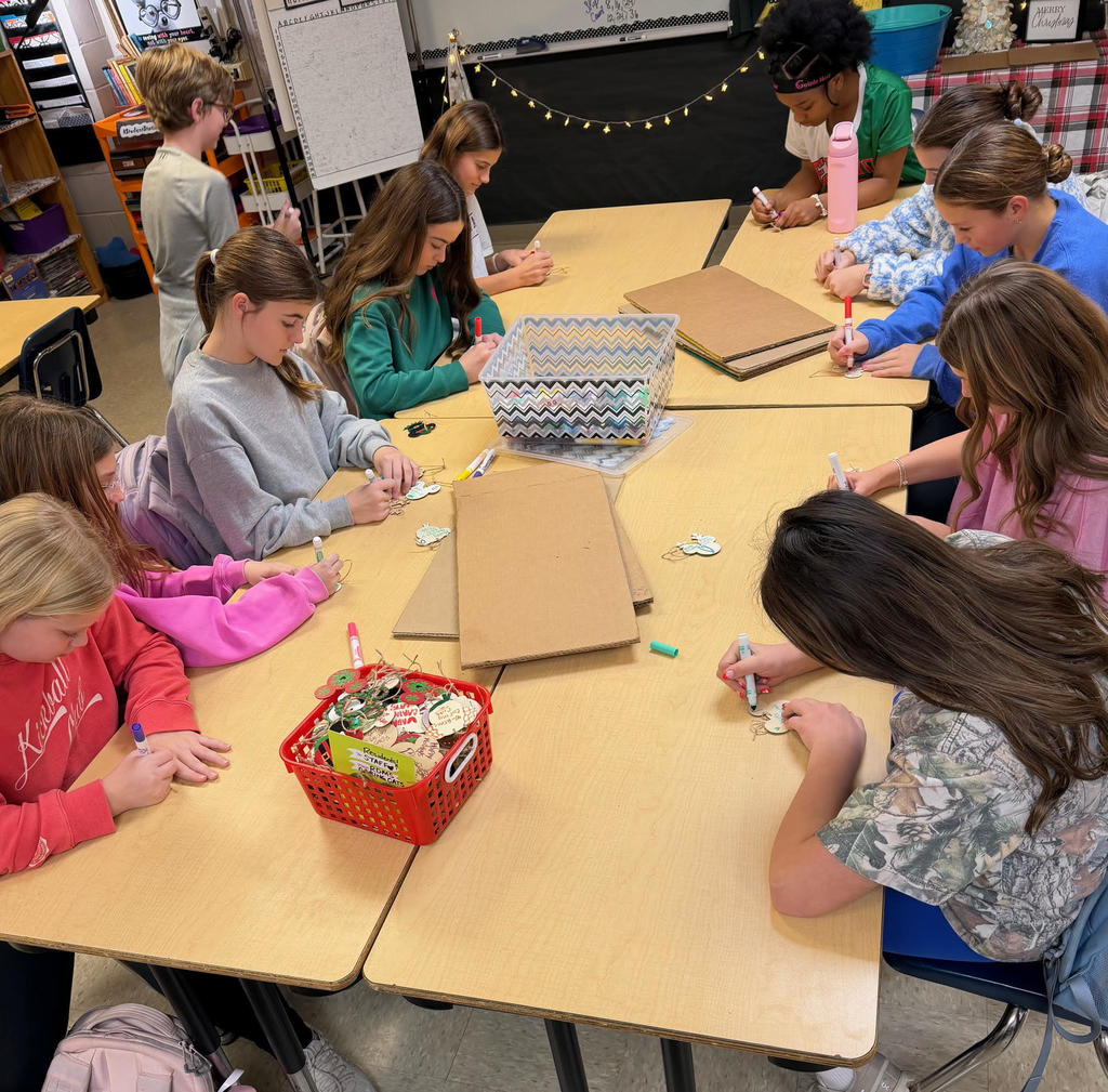 Students making holiday ornaments.