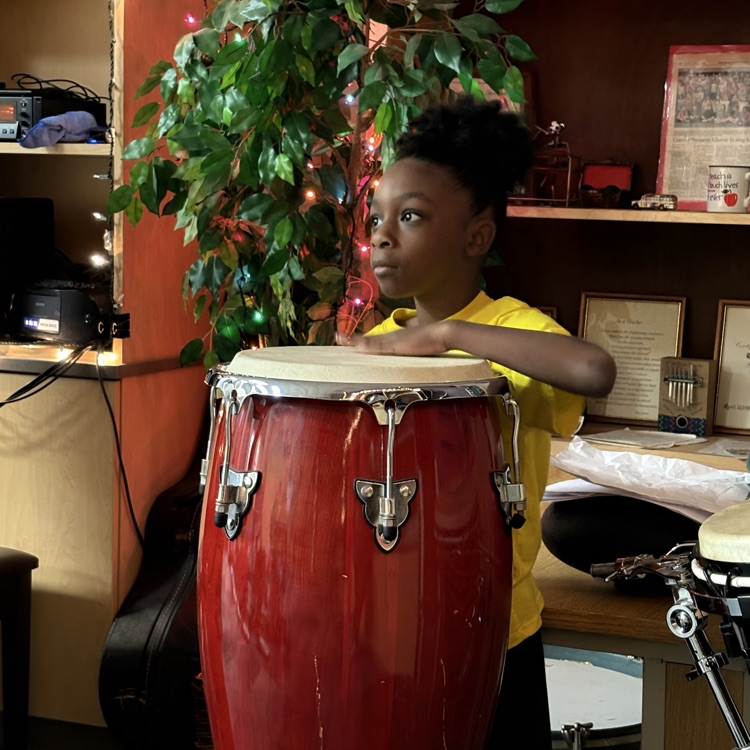 student playing drum