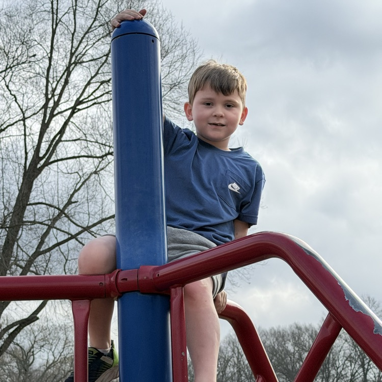 kid on playground equipment 