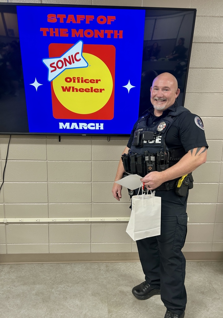 Officer wheeler holding his gift card for being chosen for Staff of the Month for March