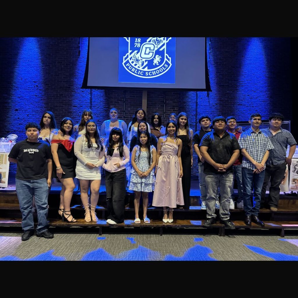 ESL Graduates standing on stage.