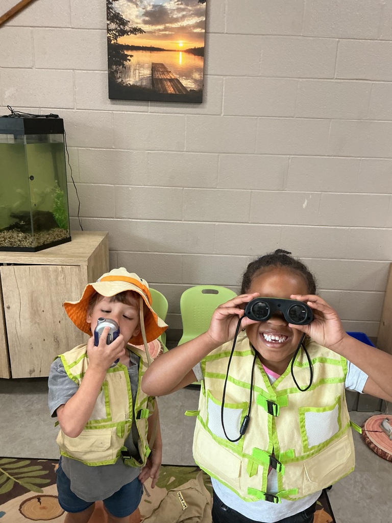 children playing in dramatic play wearing camping gear