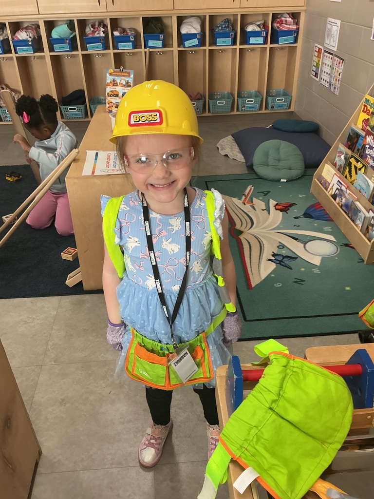 child demonstrating how to wear the safety gear while building 