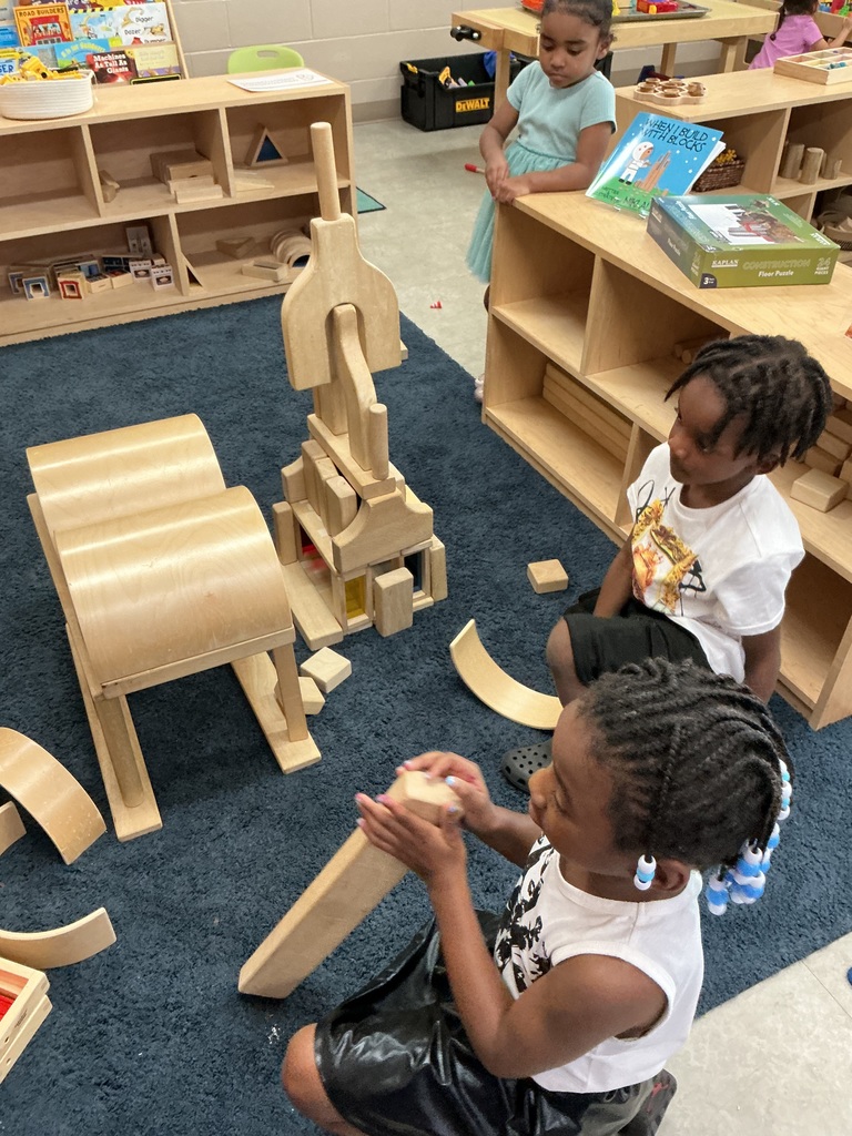 children using wooden blocks to create a ramp