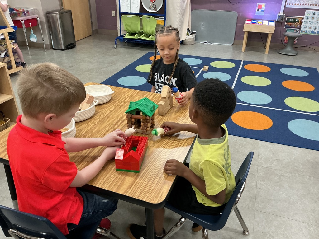boys building homes for three little pigs 