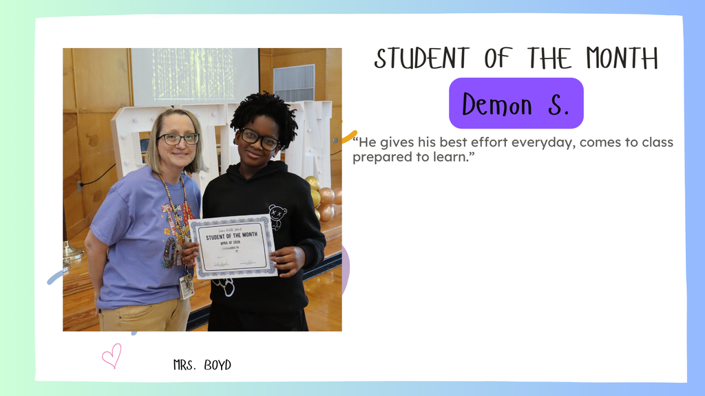 Demon S. Simon's April Student of the month smiling with his certificate. Posing with Mrs. Boyd
