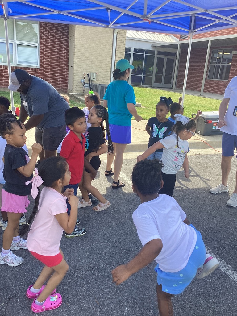 children and teachers dancing