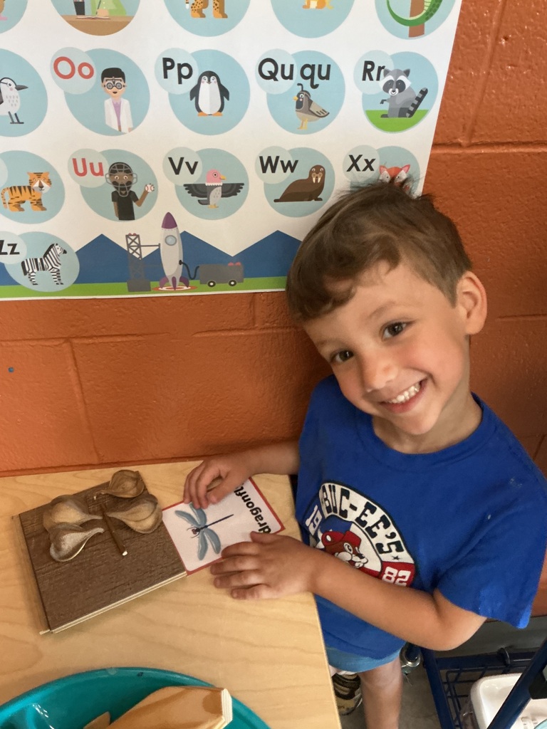 child using loose parts to design a bug