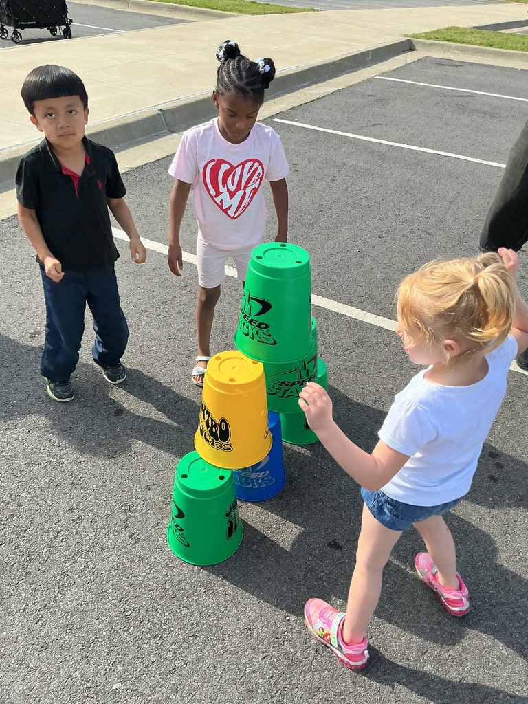 children playing cup stacking game