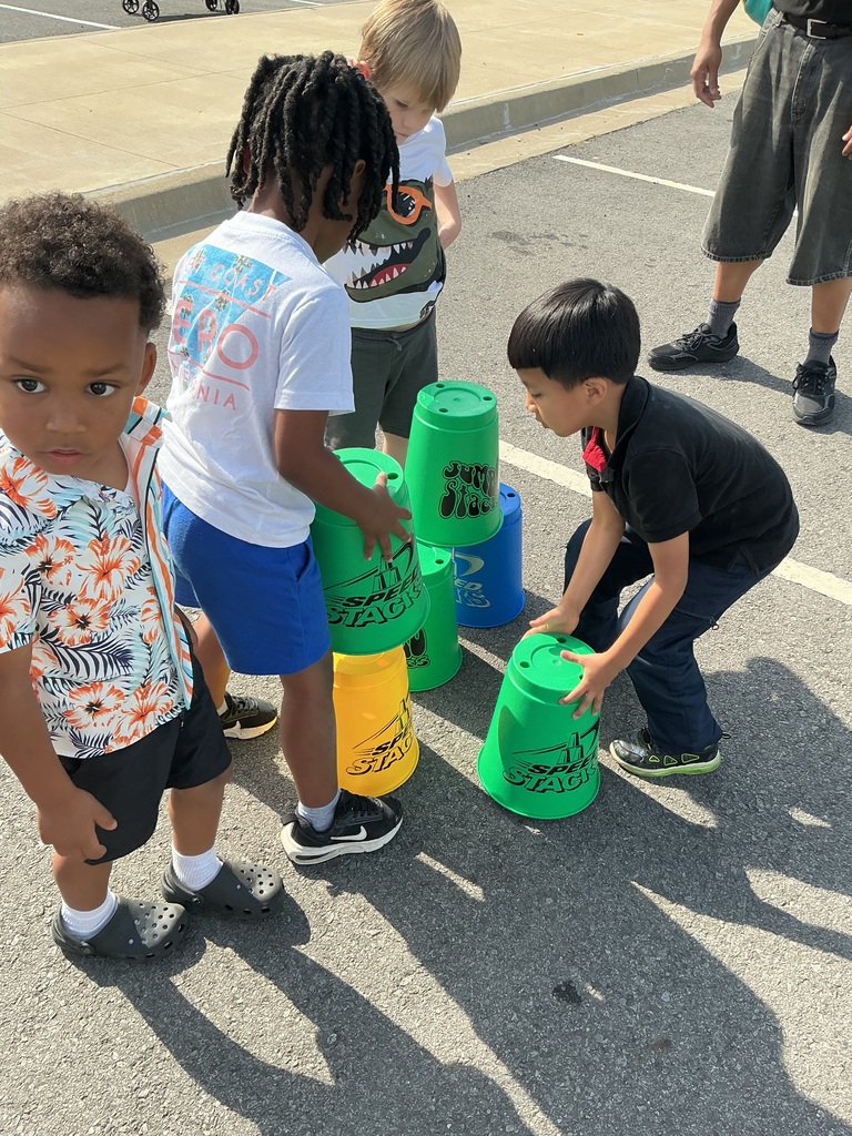 children playing cup stacking game