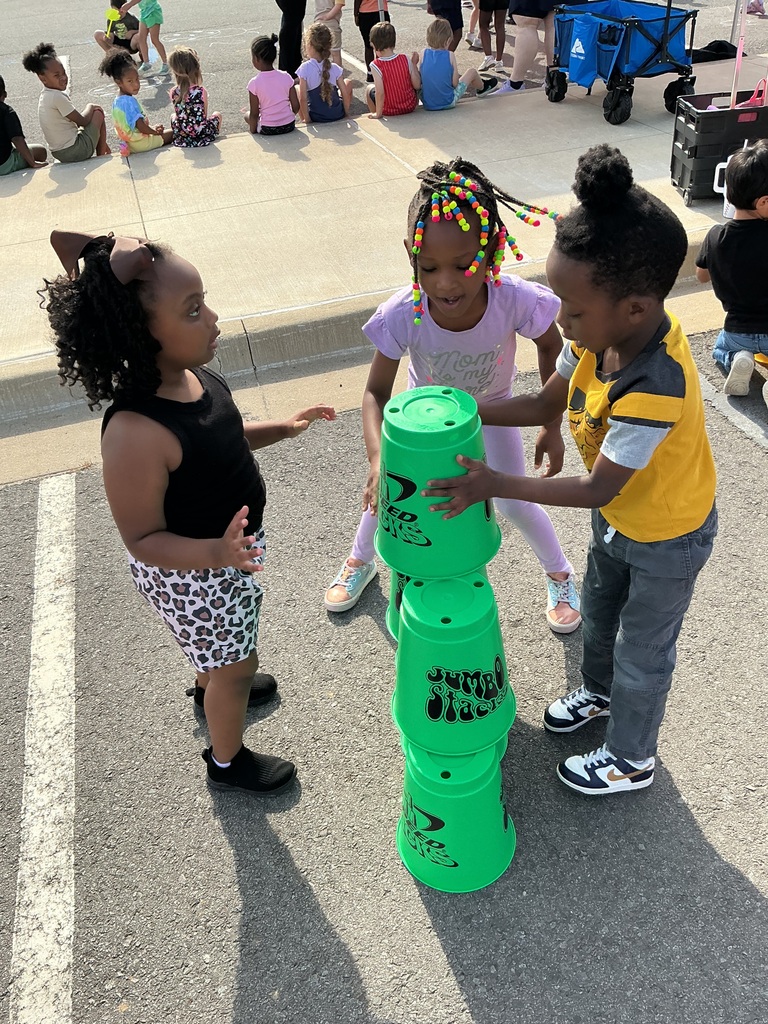 children playing cup stacking game