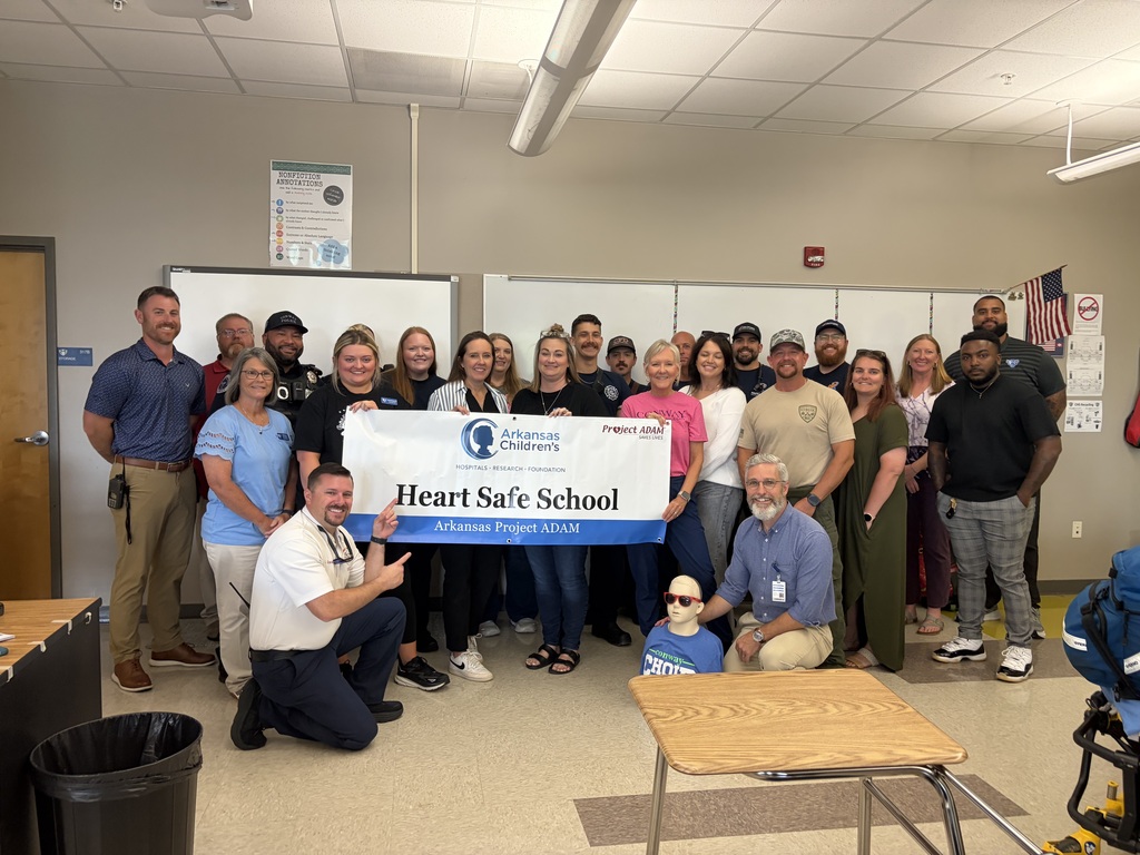 Members of CHS admin and staff posing with a banner designating the campus as a "Heart Safe School"