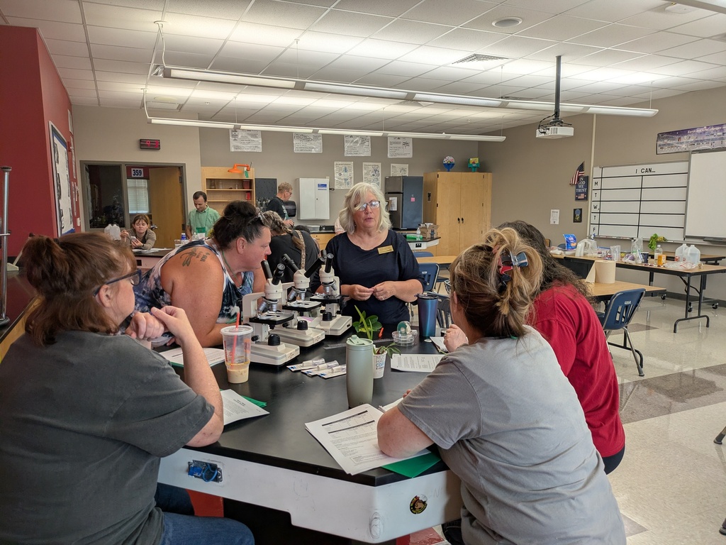 Small group of teachers around a lab table working with a presenter.