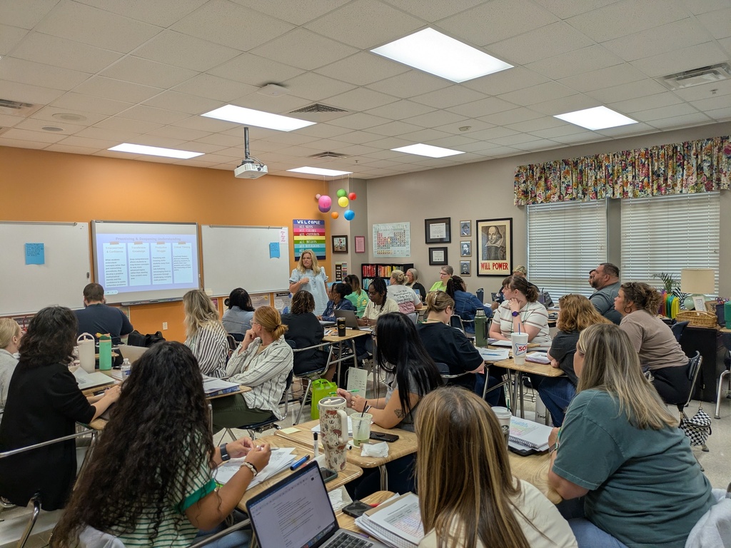Classroom with a large group of educators listening to a presenter.
