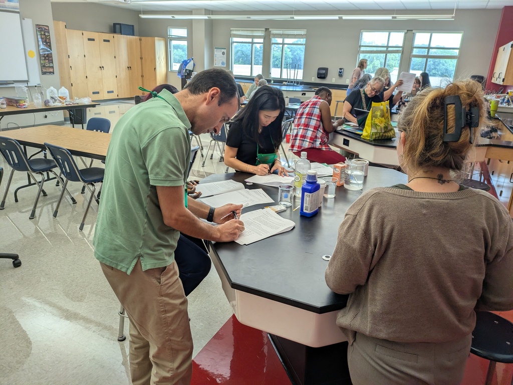 Small group of teachers around a lab table working through an activity.