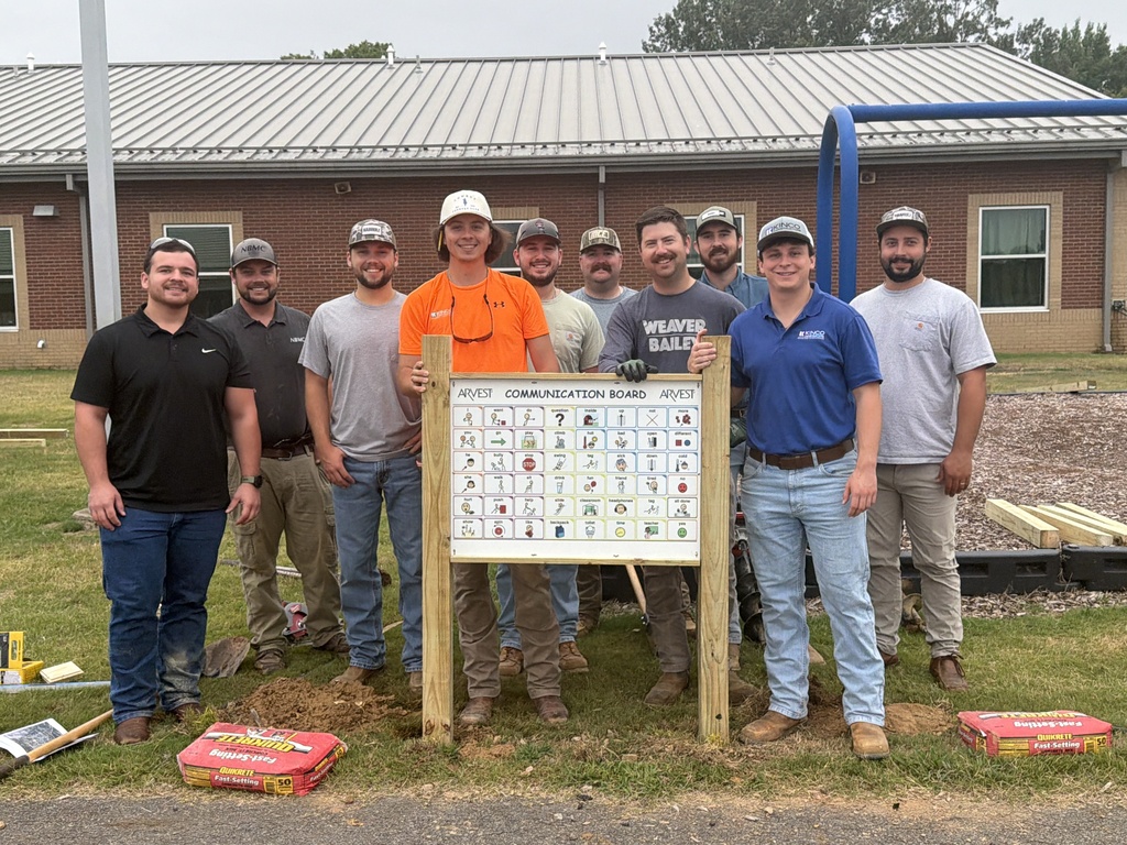 group photo of men that installed the commuication boards on CPSD playgrounds.