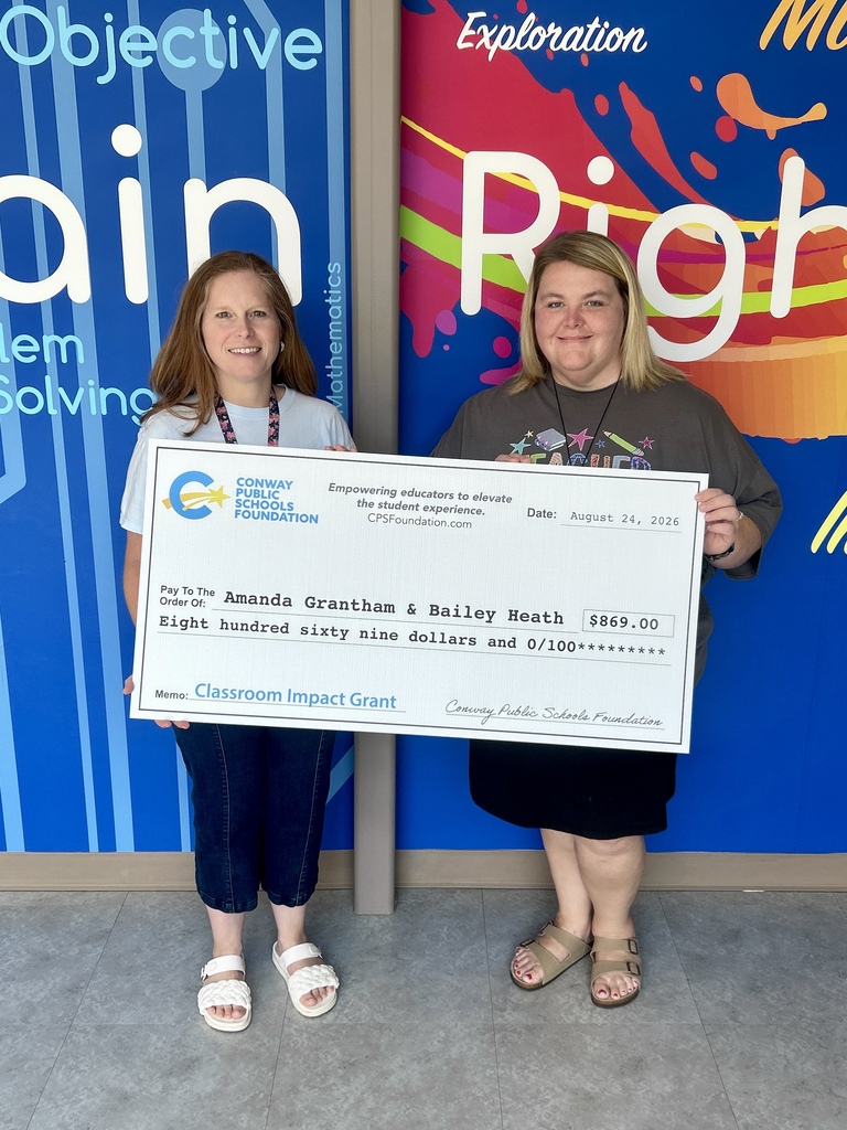 teachers holding grant check